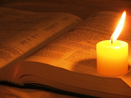 Burning candle -- wax about to ruin a perfectly good Bible