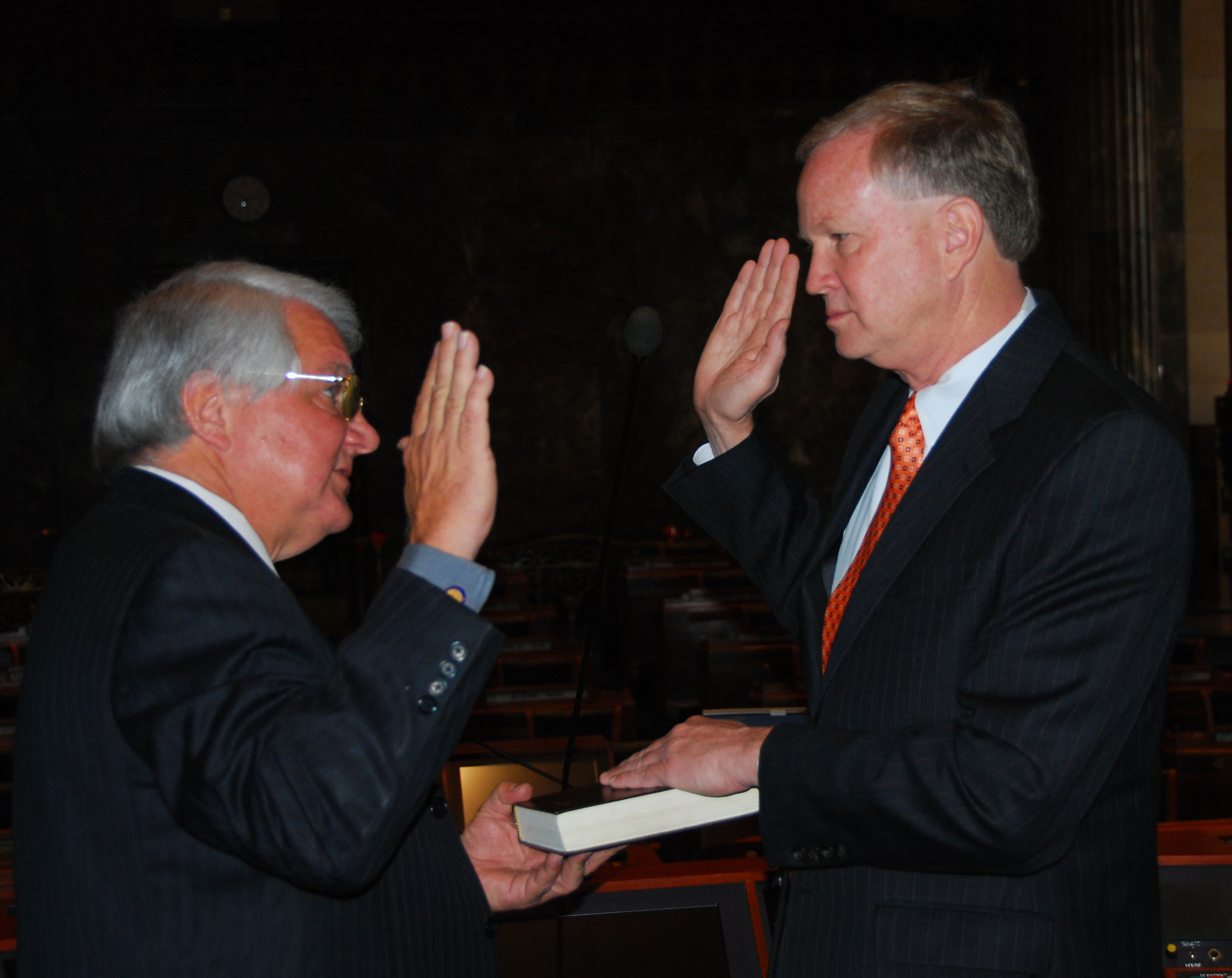 Ambassador Farere is sworn in by Father Brymstone